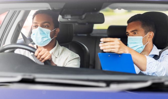 instructor-and-student-with-facemasks-in-car-feature